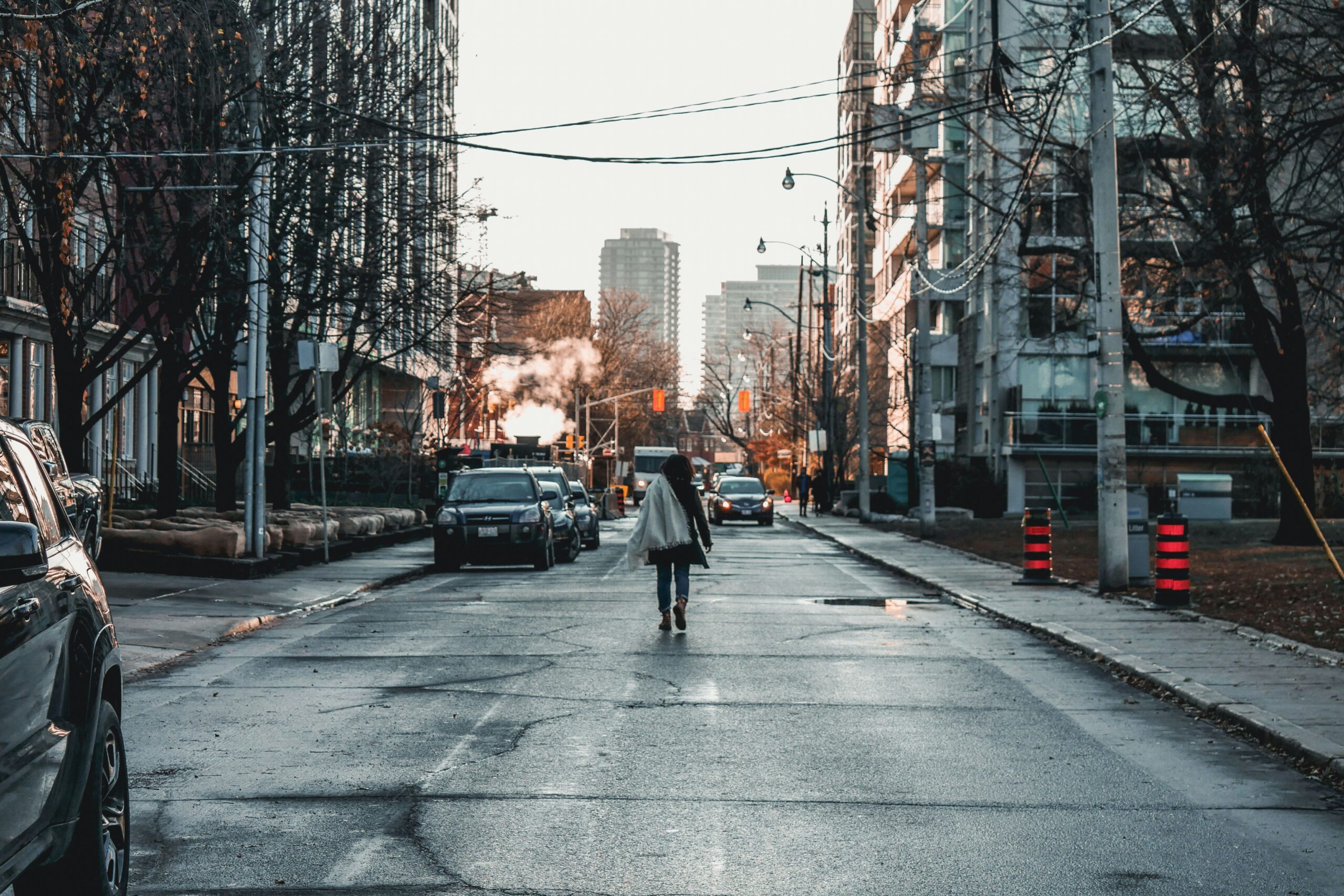 A woman walking alone down a city street